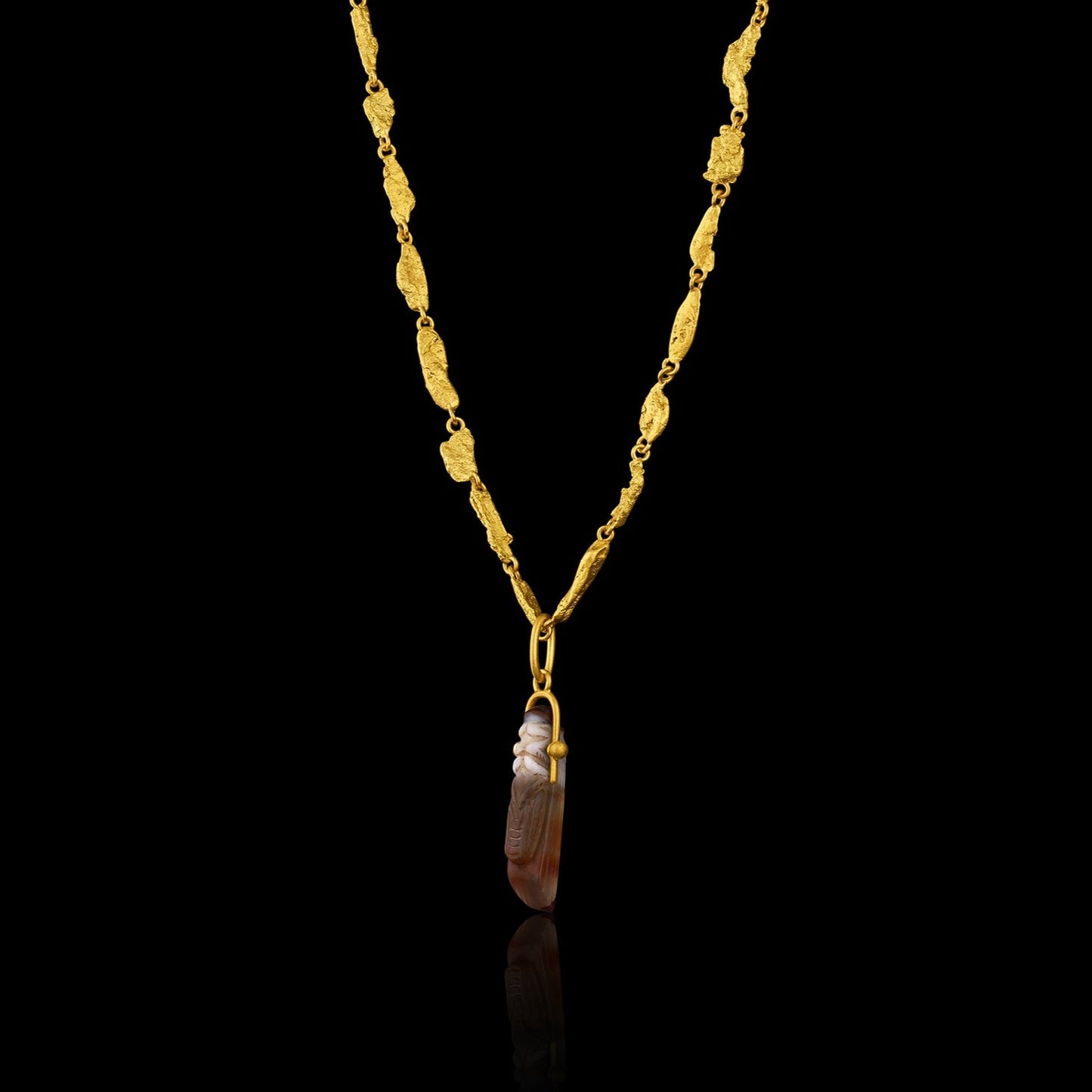 Ancient Greek Agate Grasshopper (c. 300-200 BCE) suspended from a modern gold bail. Hanging on gold flake chain.