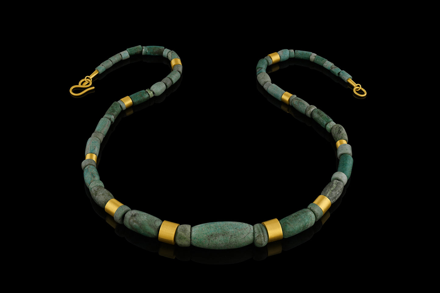 Iranian turquoise bead and gold necklace on leather.