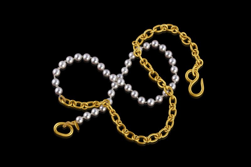 Elegant and playful, this combination necklace is half Akoya pearls and half handmade chain in 22k yellow gold. Closes with our signature shepherd's hook clasp. Pearls are individually hand tied on silk.