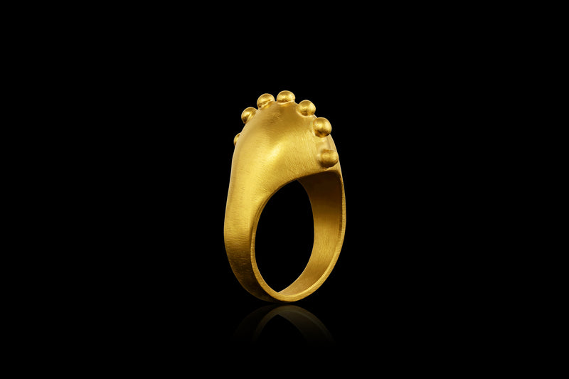 A 22k gold ring with a spine of golden spheres - angled view