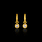 Gold earrings with antique diamonds on a black background