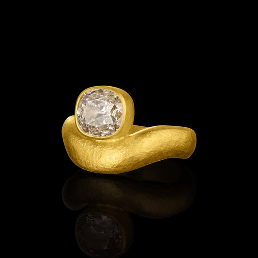 Gold ring with an Antique Cushion-Cut Diamond on a black background