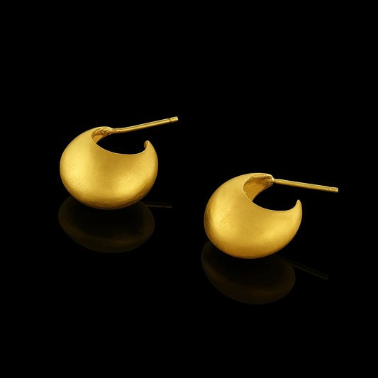 Pair of gold hoop earrings on a black background