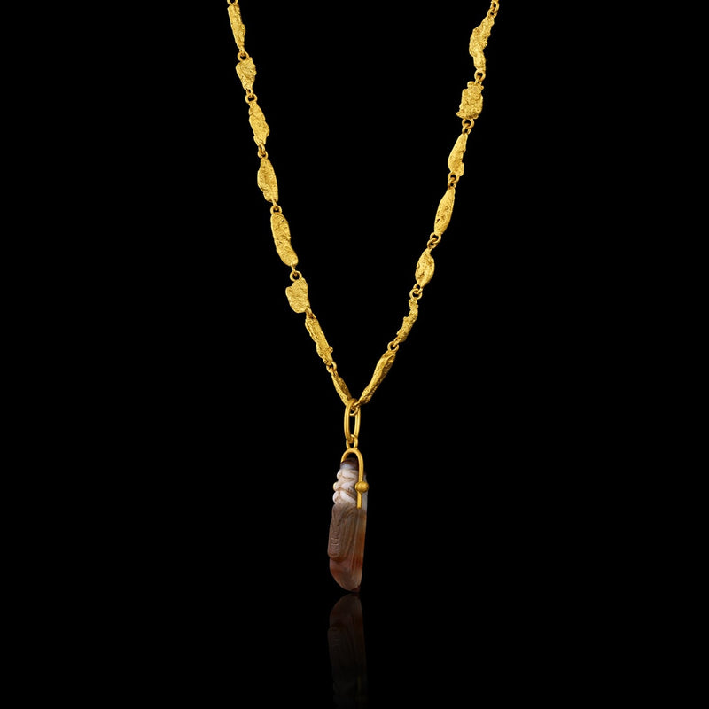 Ancient Greek Agate Grasshopper (c. 300-200 BCE) suspended from a modern gold bail. Hanging on gold flake chain.