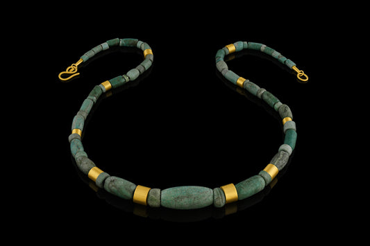 Iranian turquoise bead and gold necklace on leather.
