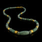 Iranian turquoise bead and gold necklace on leather.