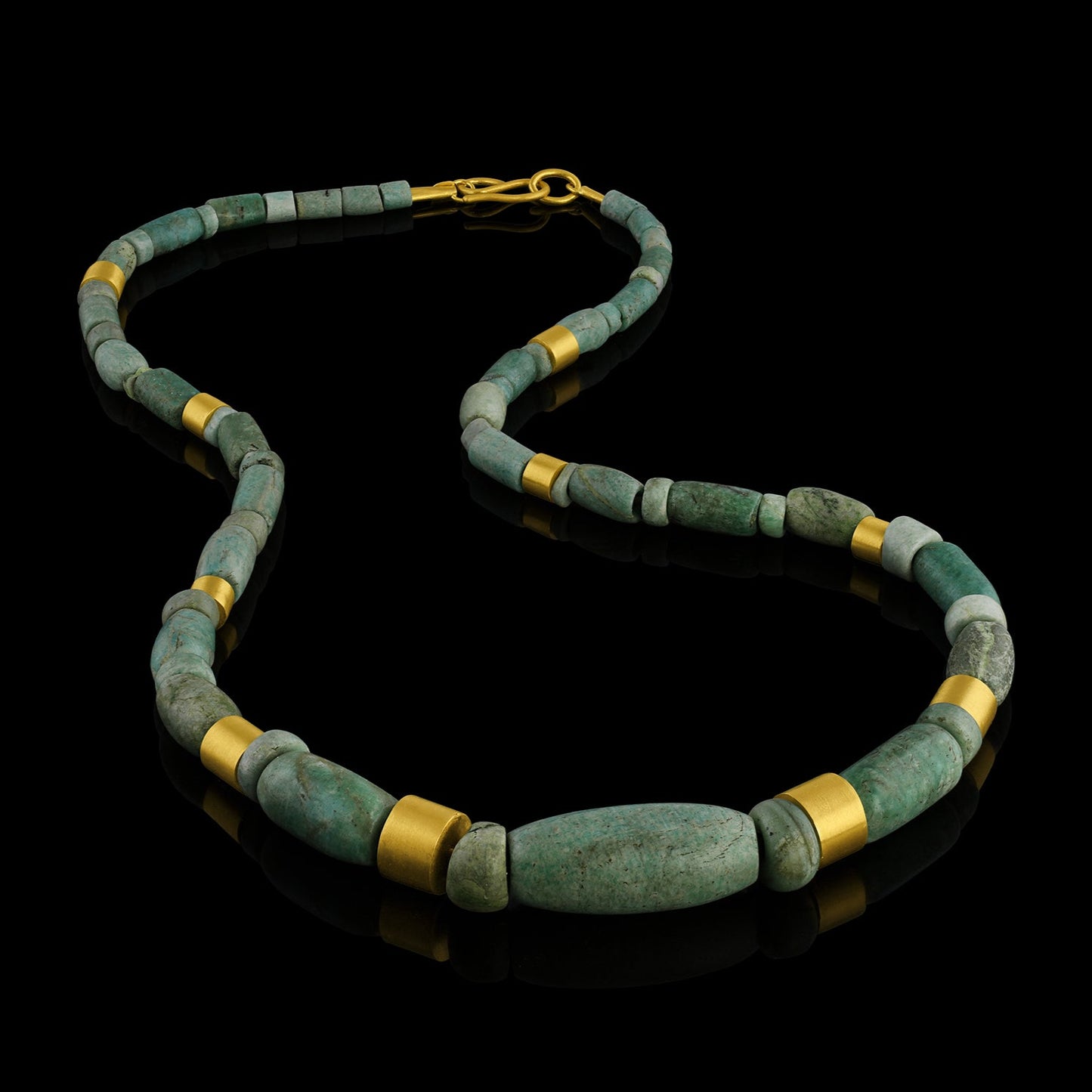 Iranian turquoise bead and gold necklace on leather.