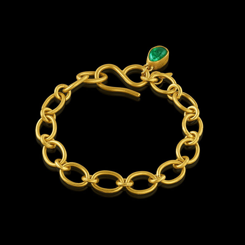 bracelet made of flexible handmade cable chain suspending 1 bezel-set Colombian emerald tumble.