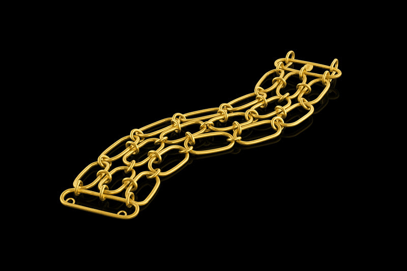 A handmade 22-karat gold chain bracelet composed of three lines of oval links interconnected by smaller links.