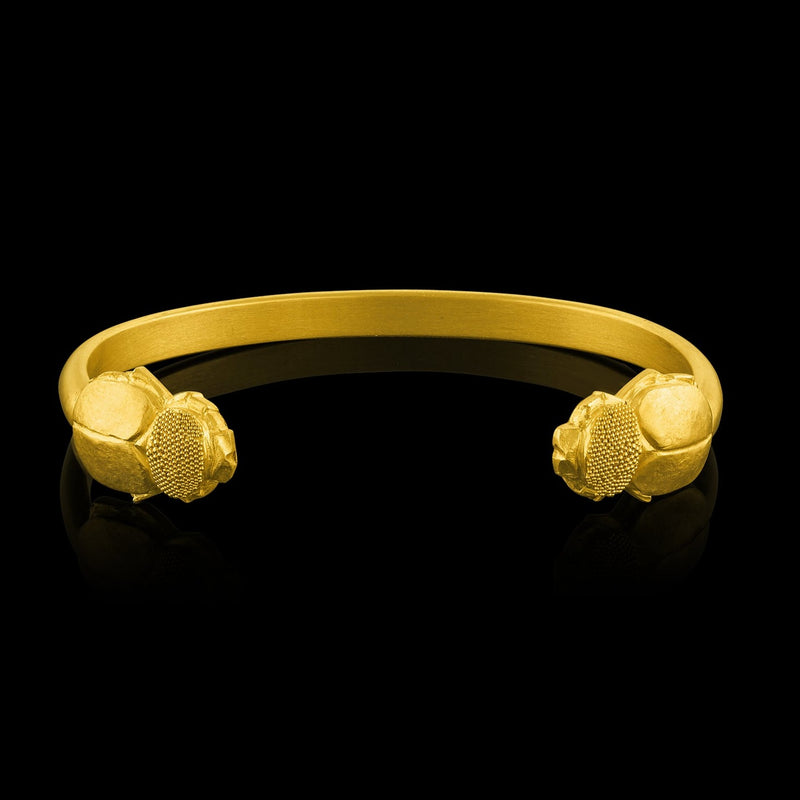 A 22-karat gold cuff bracelet with scarab beetle terminals.