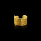 An ear cuff formed from a hammered sheet of gold with an organic edge inspired by papyrus, the reed paper used by the ancient Egyptians.