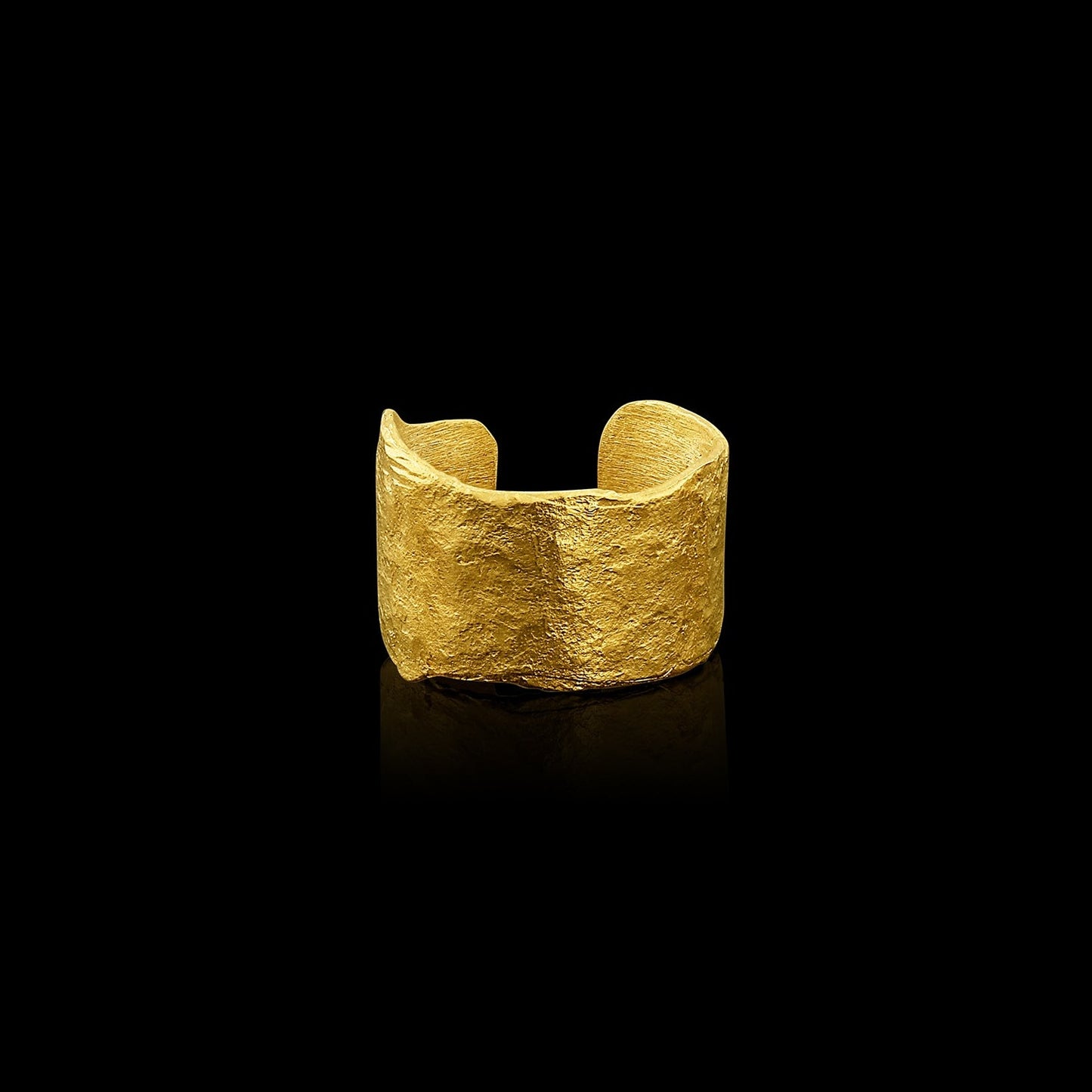 An ear cuff formed from a hammered sheet of gold with an organic edge inspired by papyrus, the reed paper used by the ancient Egyptians.