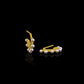 Flat gold huggie hoop earring with seven white pearls along the edge.  Standing view.