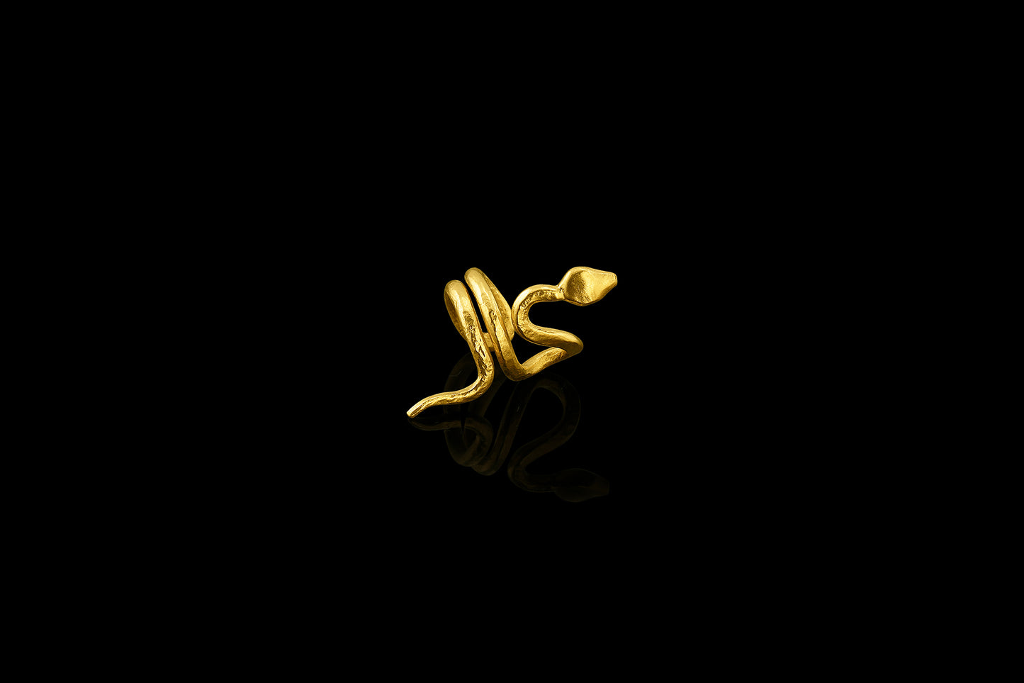 With sinuous curves that climb up the ear, this 22-karat yellow gold snake cuff is beautifully balanced. (right ear)