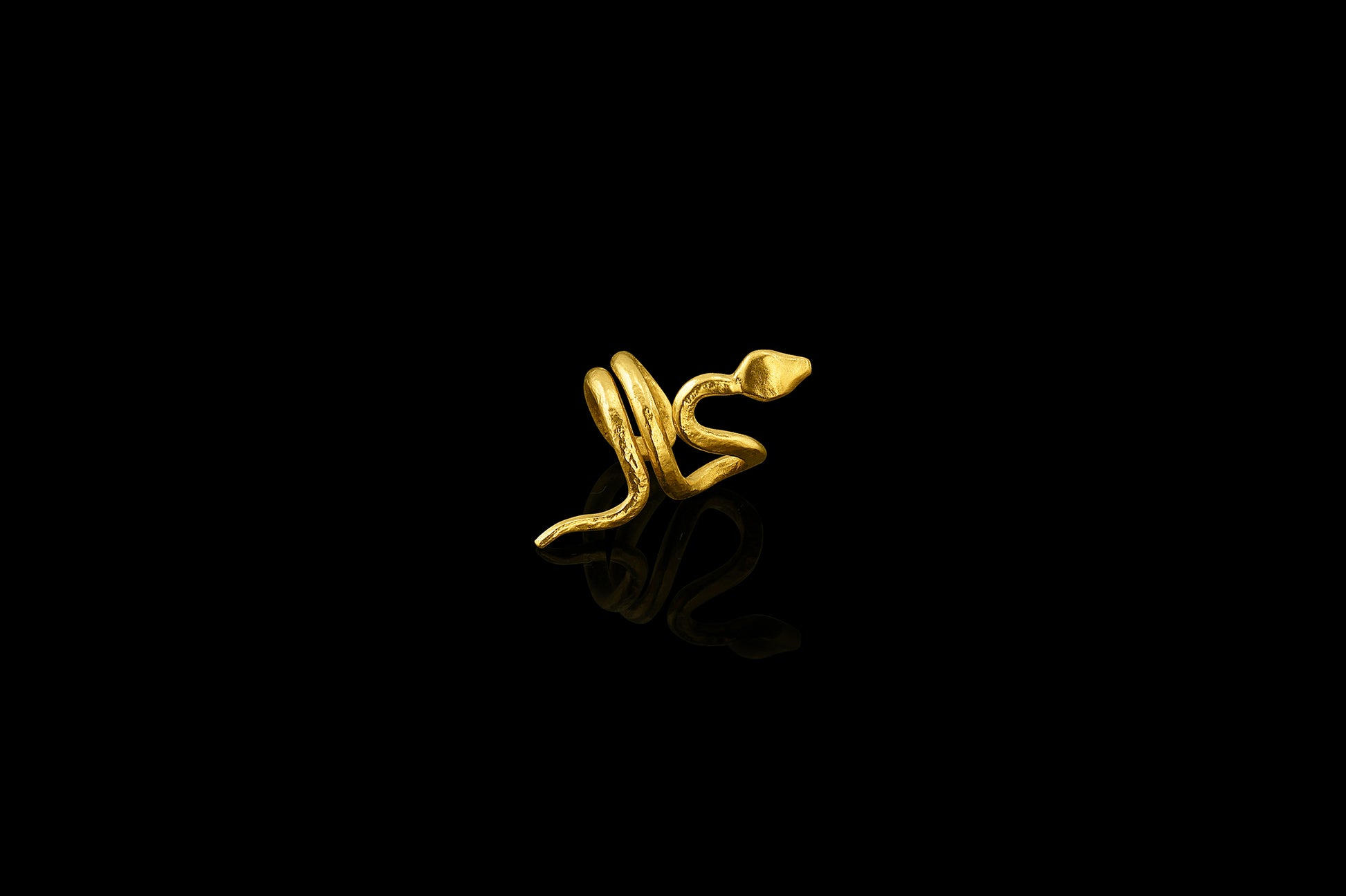 With sinuous curves that climb up the ear, this 22-karat yellow gold snake cuff is beautifully balanced. (right ear)