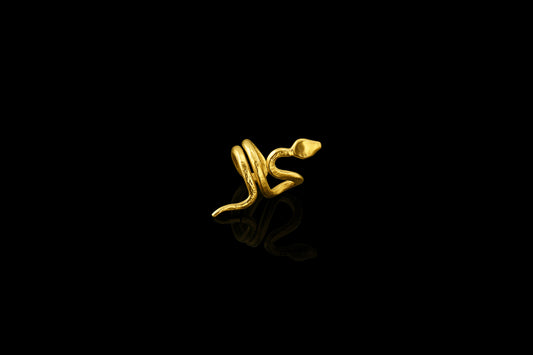 With sinuous curves that climb up the ear, this 22-karat yellow gold snake cuff is beautifully balanced. (right ear)