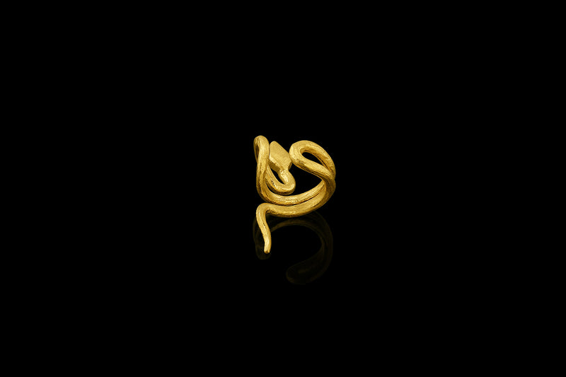 With sinuous curves that climb up the ear, this 22-karat yellow gold snake cuff is beautifully balanced. (right ear)