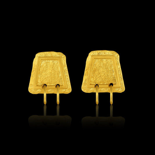 Earrings based on the shape of ancient tablets, featuring a textured surface and suspending two hoops.  