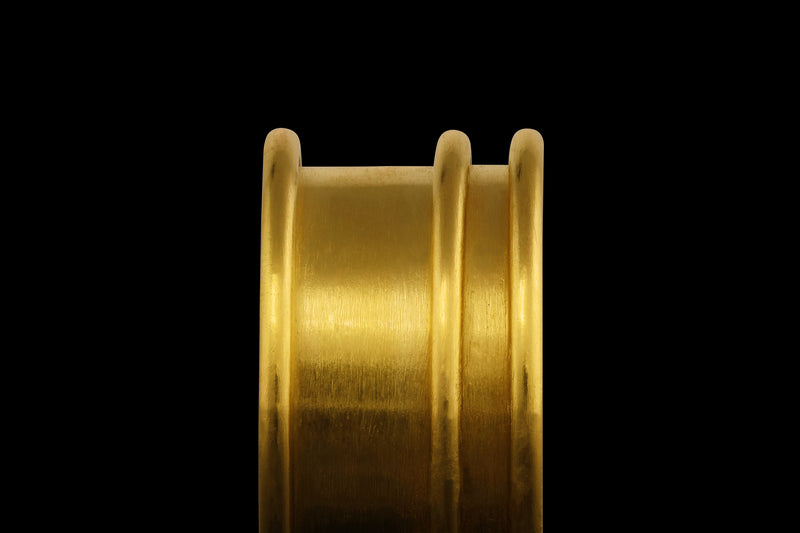 A 22k gold ring with three rounded raised lines - close up view.