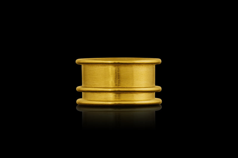 A 22k gold ring with three rounded raised lines- side view.