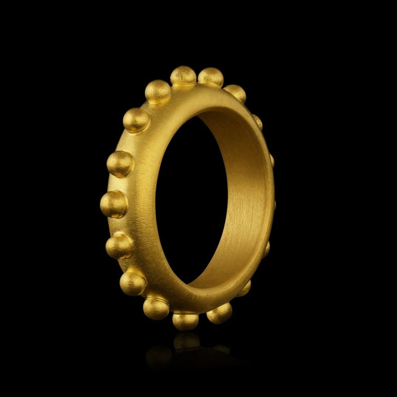 A 22k gold band ring accented with gold spheres.  