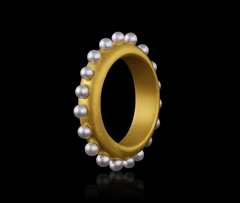 A 22k gold band ring acented with Akoya pearl spheres.  
