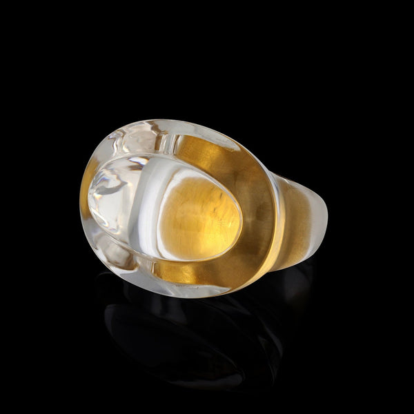 A velvet gold band sits inside a handcut polish rock crystal ring. Inspired by ancient Greecian design, this solid quartz ring has volume and layers.